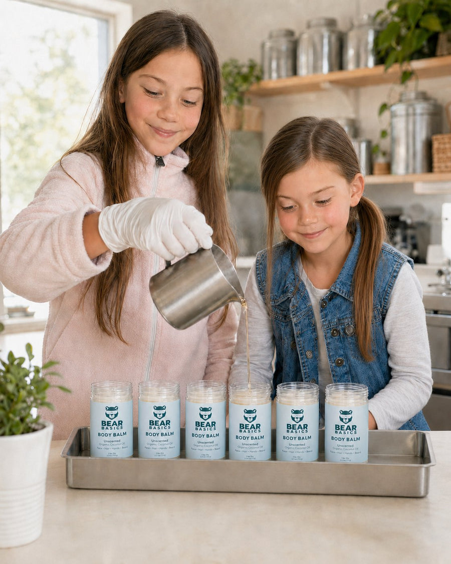 Small-batch pours — pouring Bear Basics Body Balm into tubes