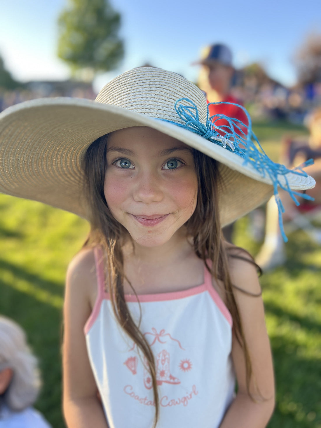Ayla, one of the Bear Basics daughters, smiling in a wide sun hat outdoors