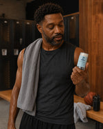 Man with Bear Basics Coconut Oil Deodorant in a locker room